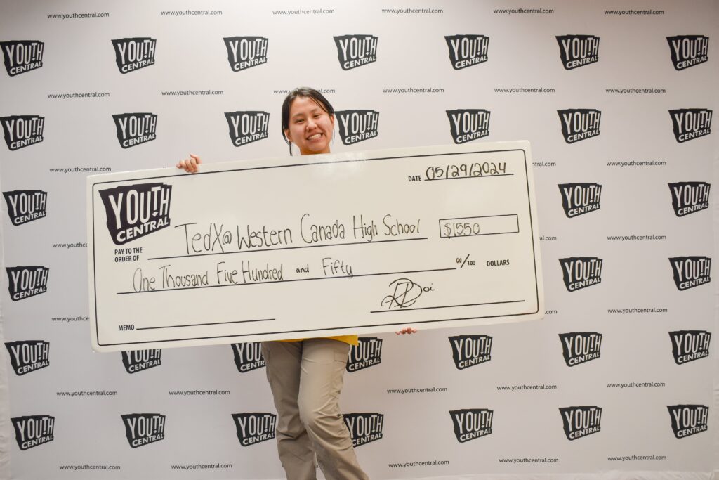 youth holding cheque made out to TedXWestern